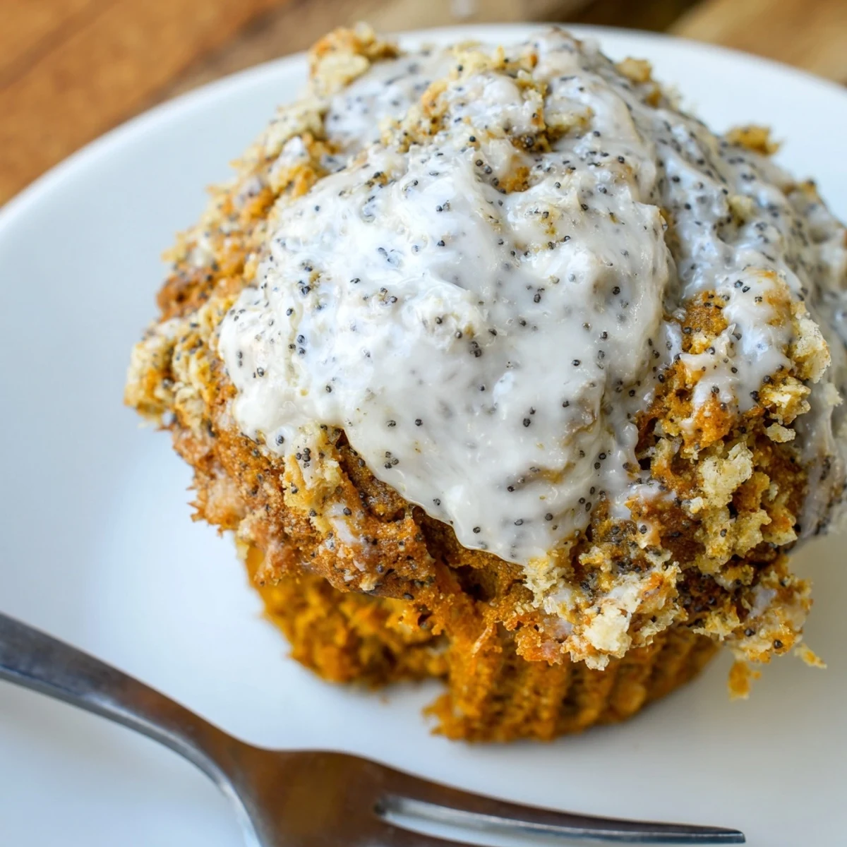 Fluffy pumpkin muffins adorned with tangy poppy seed frosting, perfect for breakfast bliss.