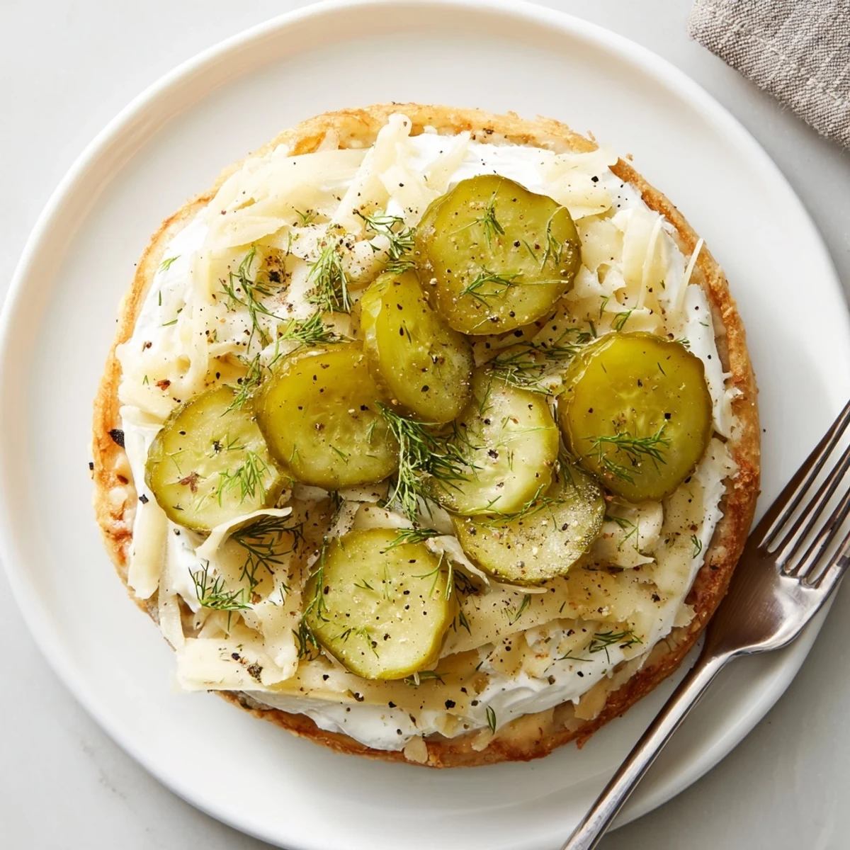 Mini pizza rounds with tangy pickles and creamy cheese, perfect for parties.