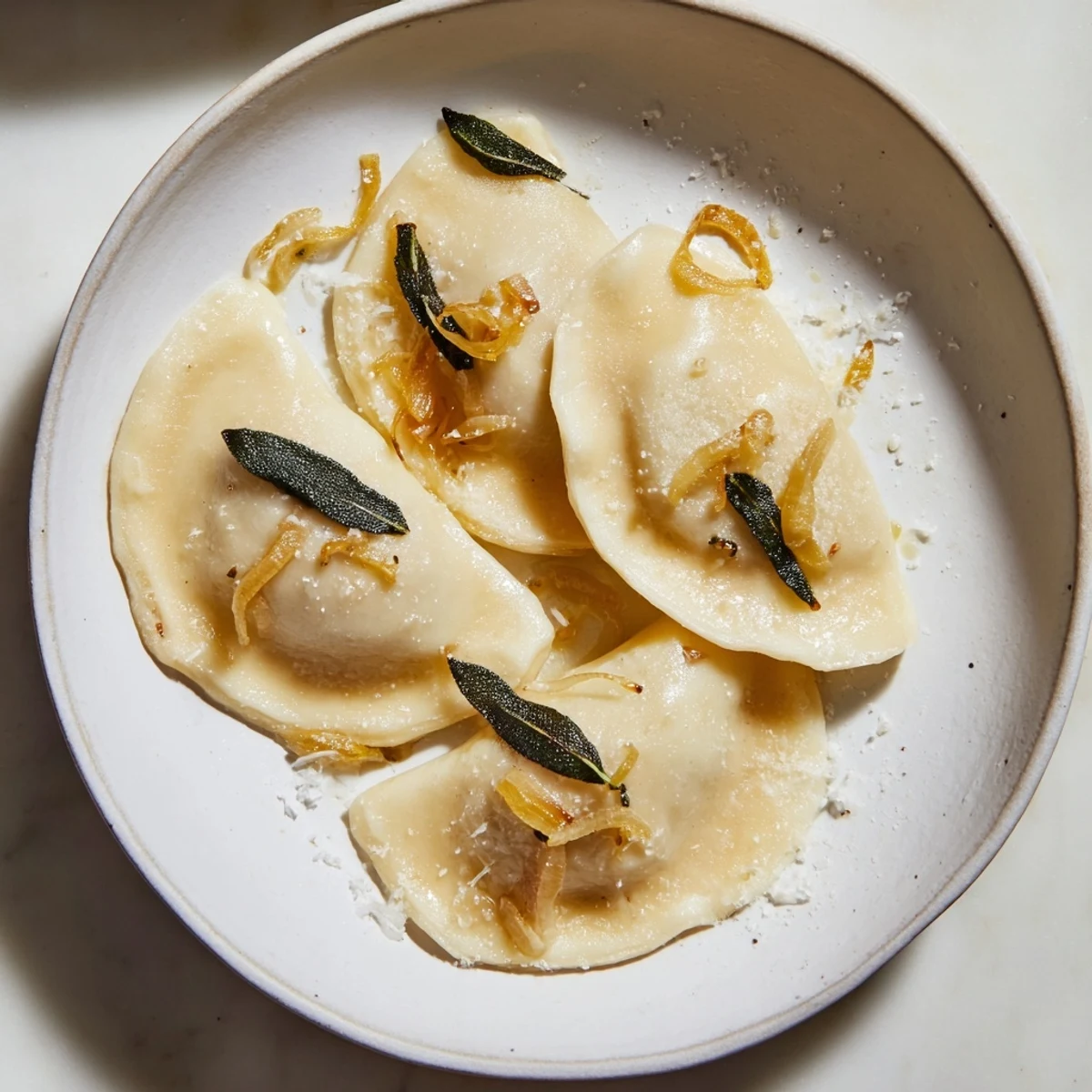 A close-up of steaming pierogi, showcasing the creamy sweet potato and sage filling.
