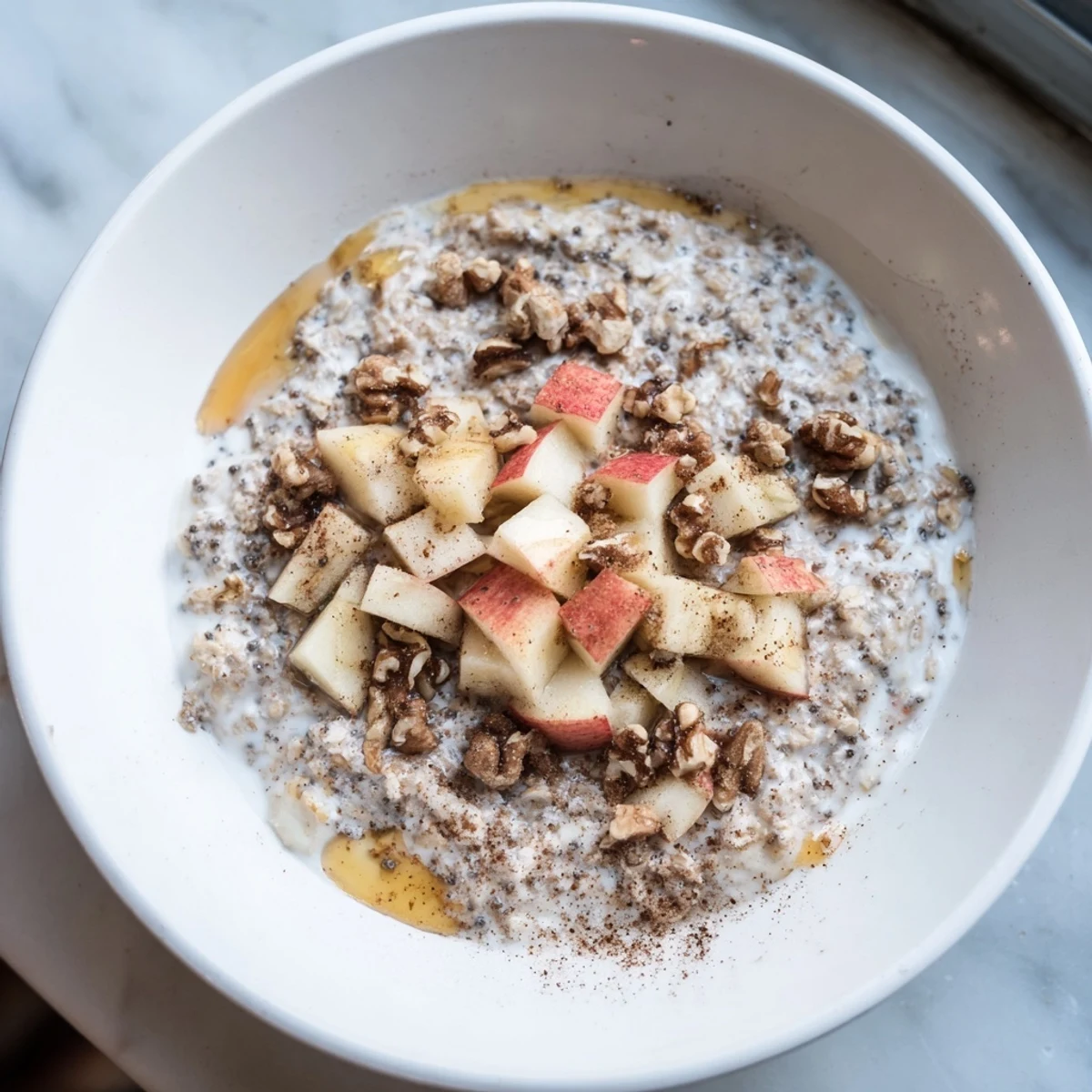 Creamy Overnight Oats with Apples, Cinnamon, and Honey: a delicious breakfast with sweet honey.
