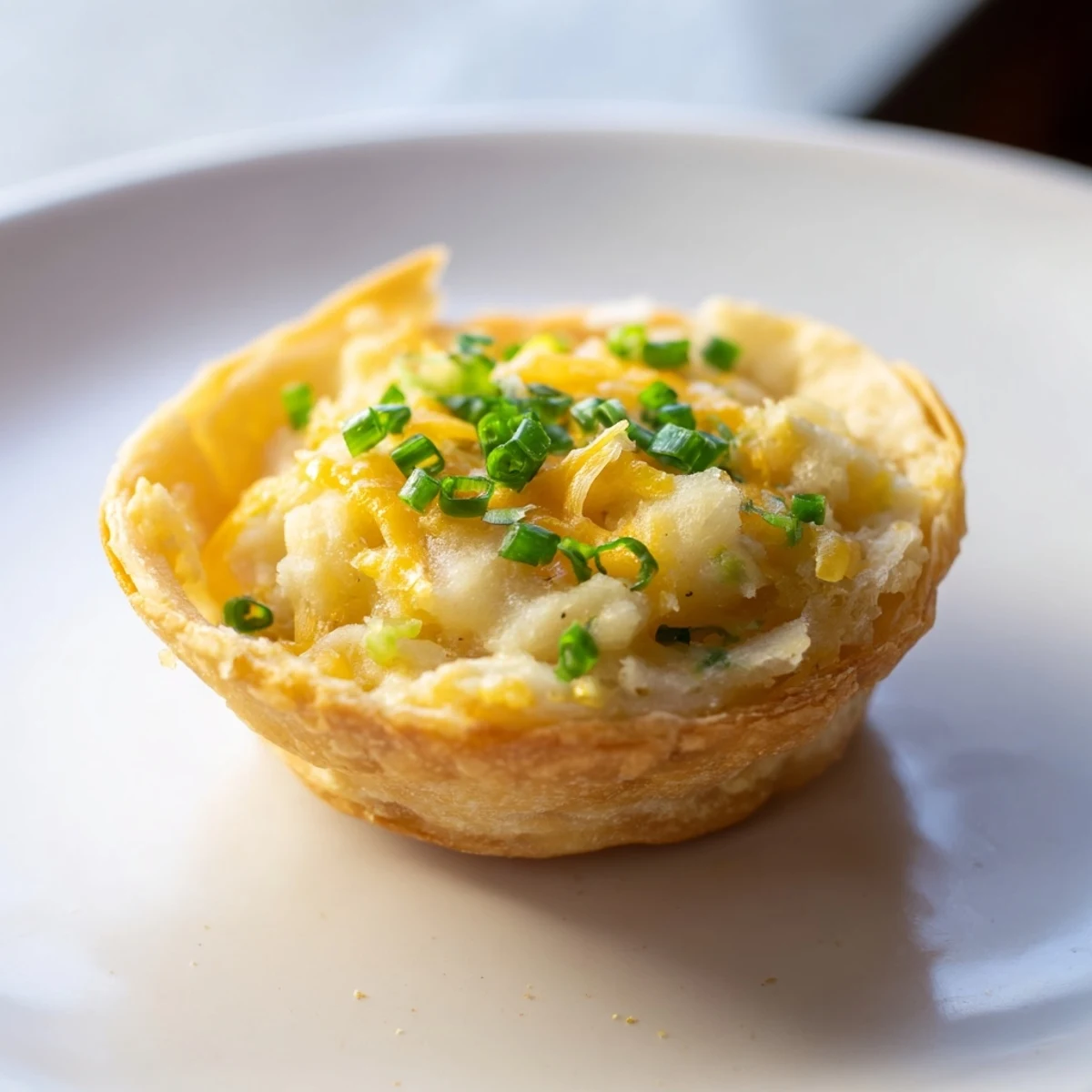 Delectable air fryer pierogi express cups, garnished with chives, a flavorful snack idea.