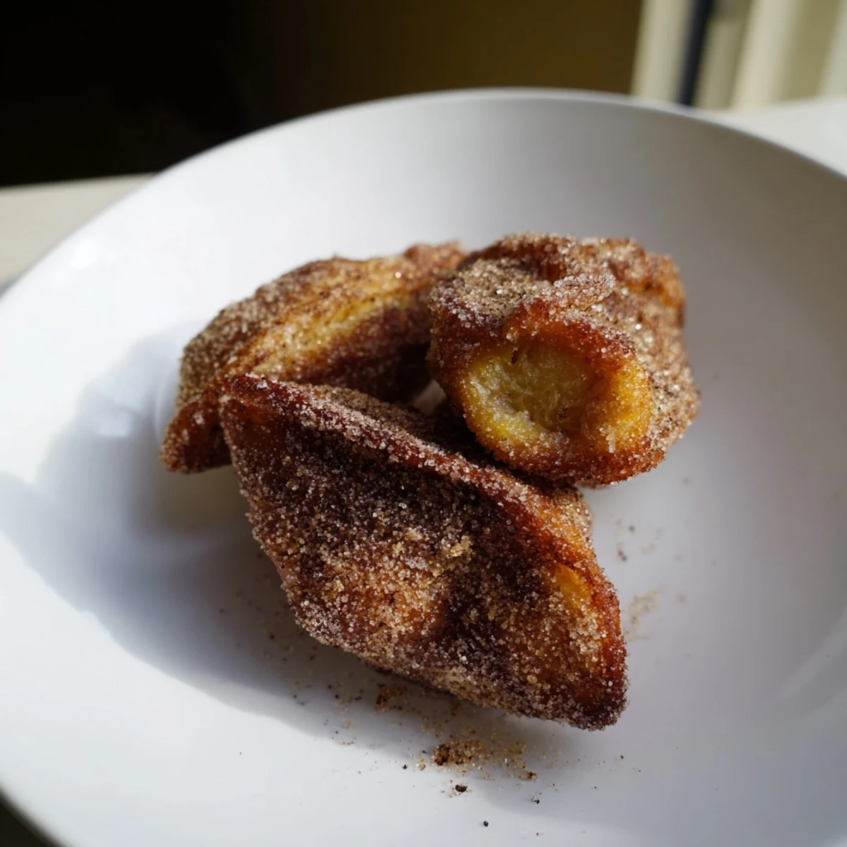 Golden-brown Express Kutab Bites dusted with powdered sugar, ready for a delicious dessert.