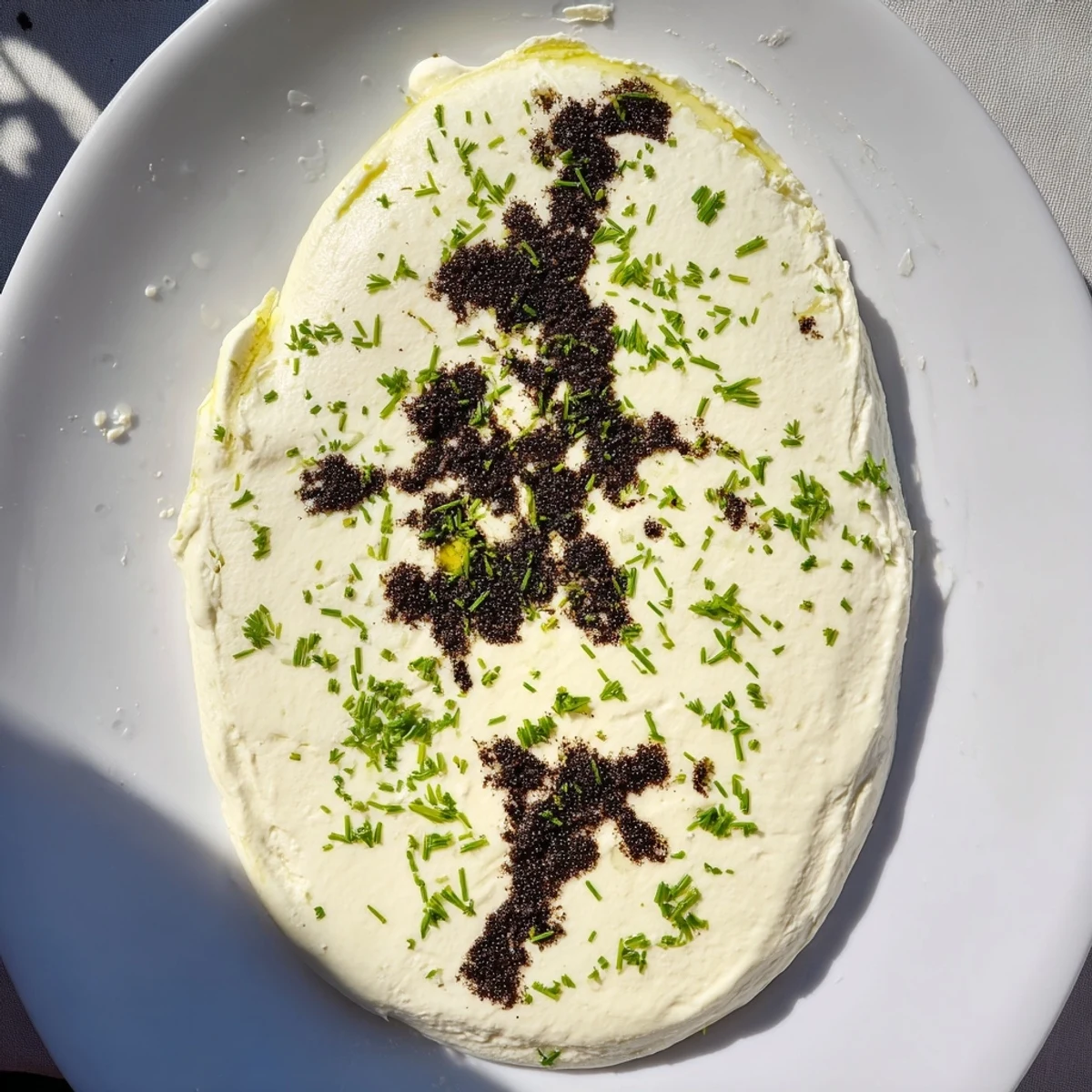 The artful Victorian Cameo appetizer with goat cheese and dark olive tapenade ready to be enjoyed.
