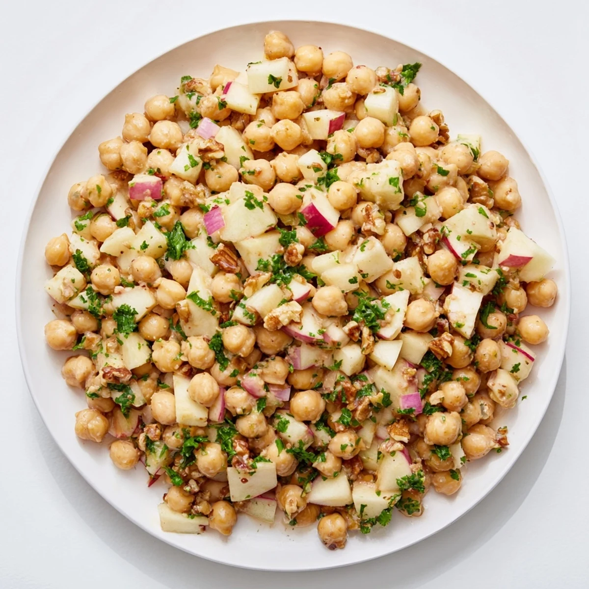 Fresh Fall Harvest Apple and Chickpea Salad brimming with crisp apples, walnuts, and a vibrant honey-mustard dressing.