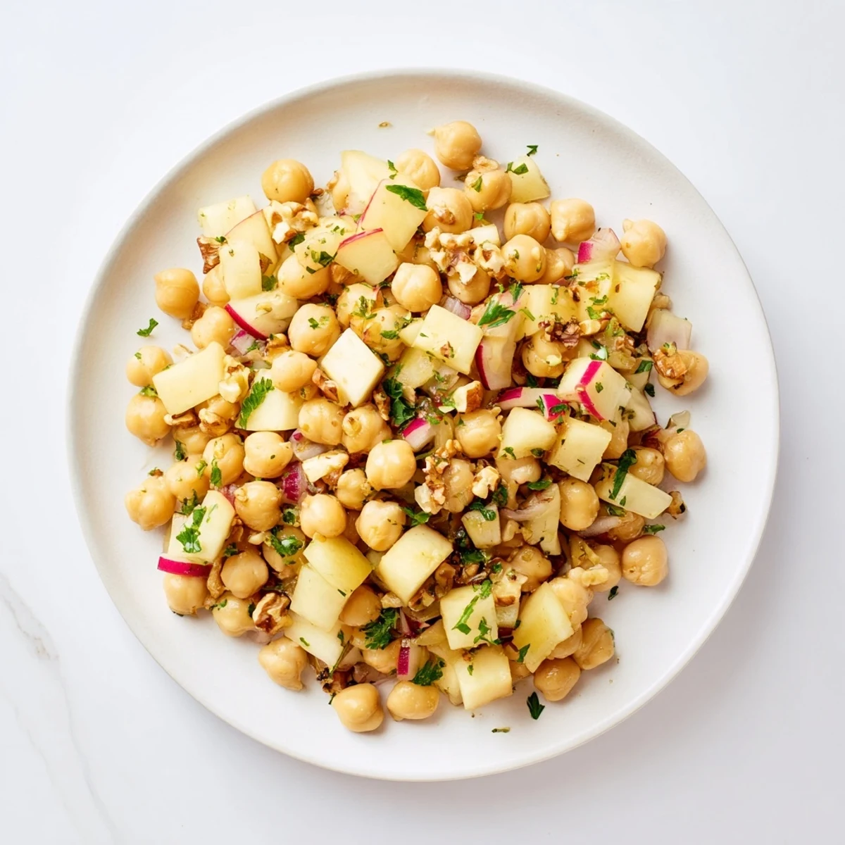 A colorful bowl of Fall Harvest Apple and Chickpea Salad, perfect for a light vegetarian lunch or side.