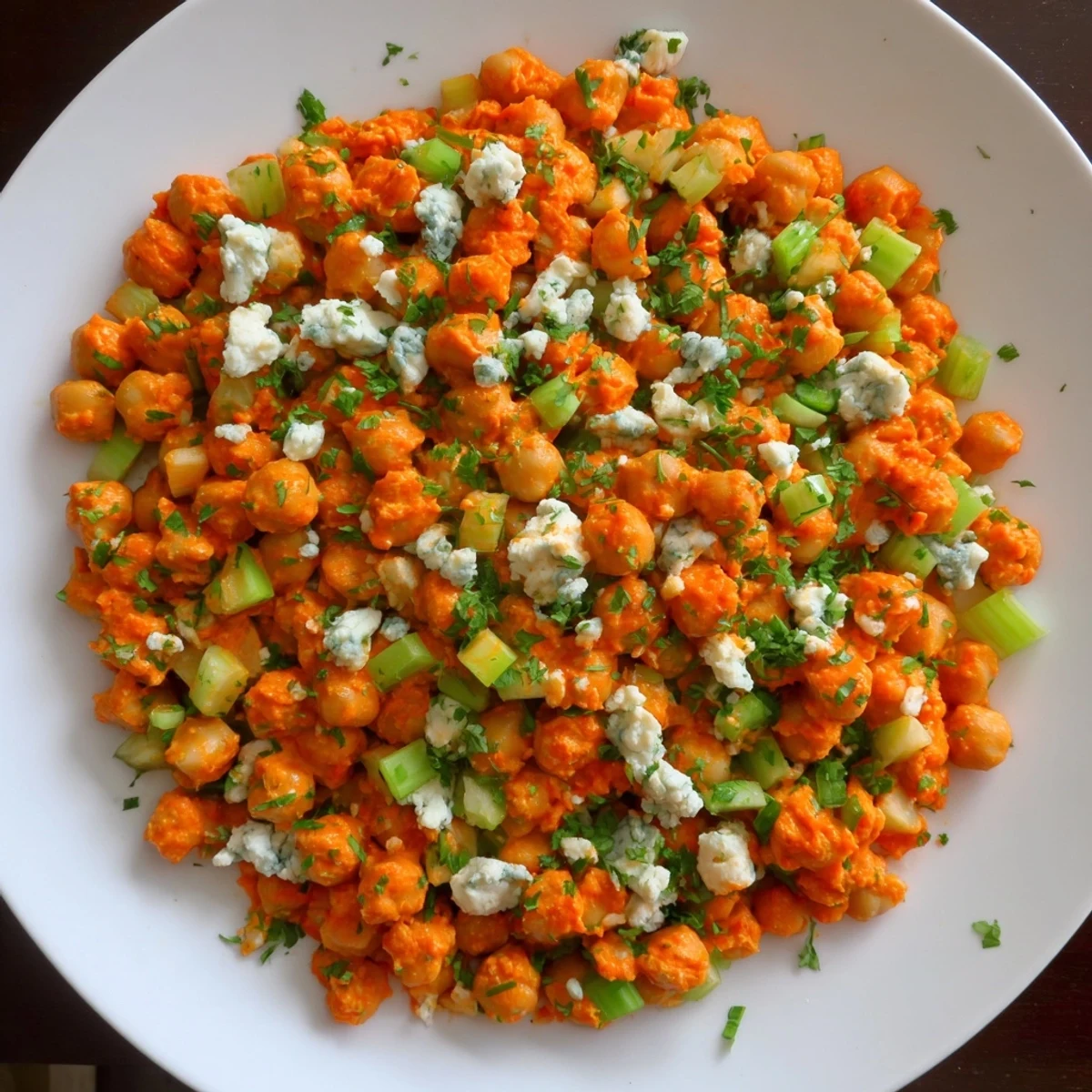 Fresh parsley garnishes a delicious bowl of buffalo chicken bean salad ready to serve.