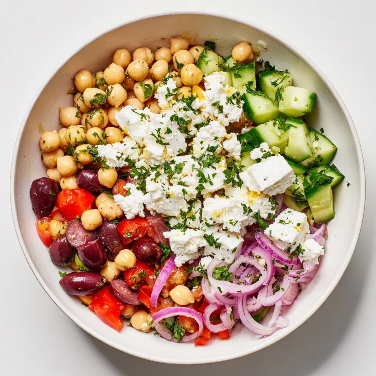 Mediterranean Chickpea and Feta Bowl, a colorful, fresh salad with crumbled vegan feta and Kalamata olives.