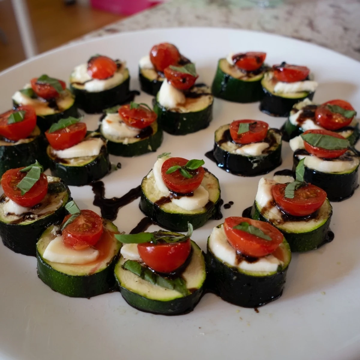 Warm Zucchini Caprese Bites, a vegetarian delight combining zucchini, mozzarella, and juicy tomatoes.