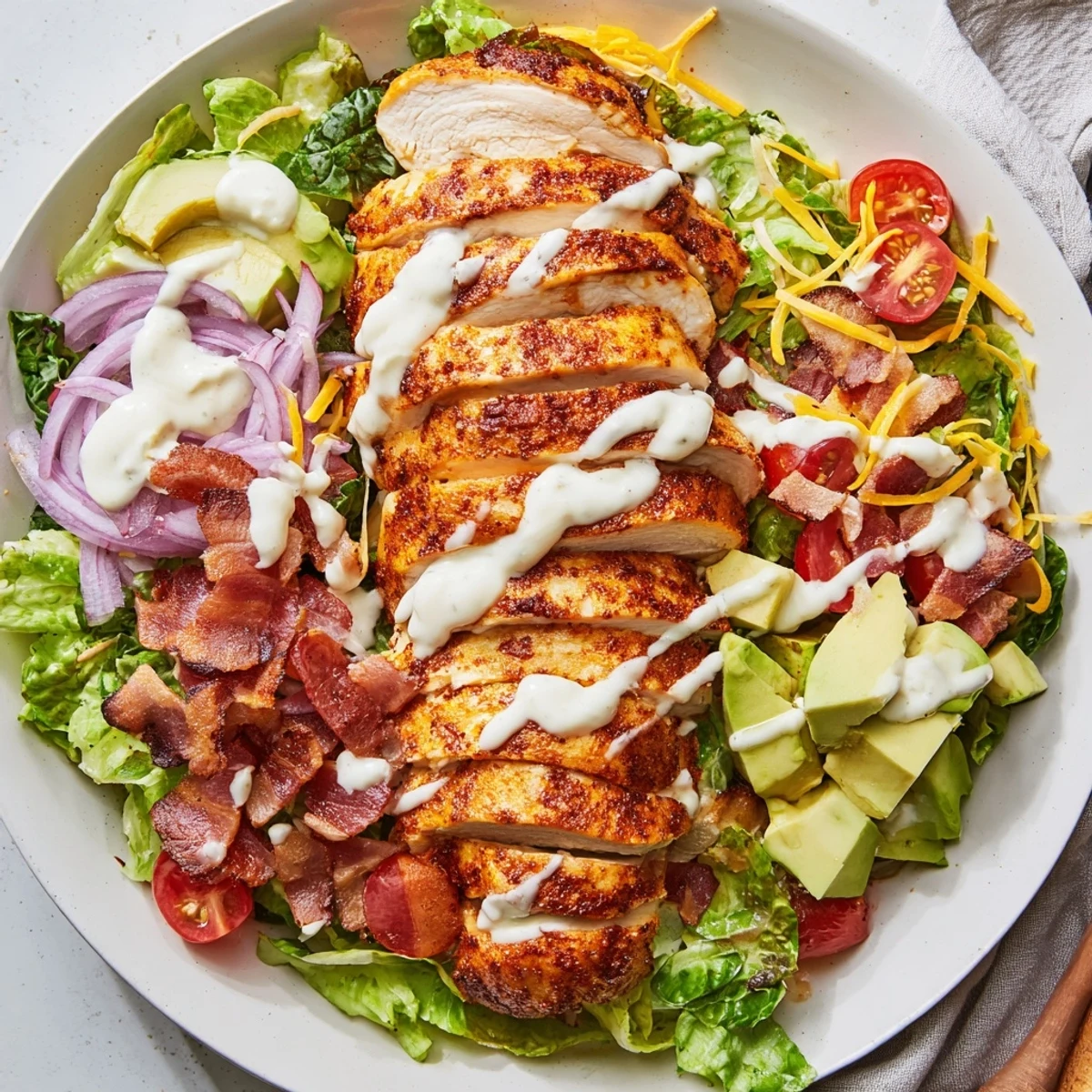Close-up of a delightful crispy bacon chicken salad, showing the textures of bacon and tender chicken.