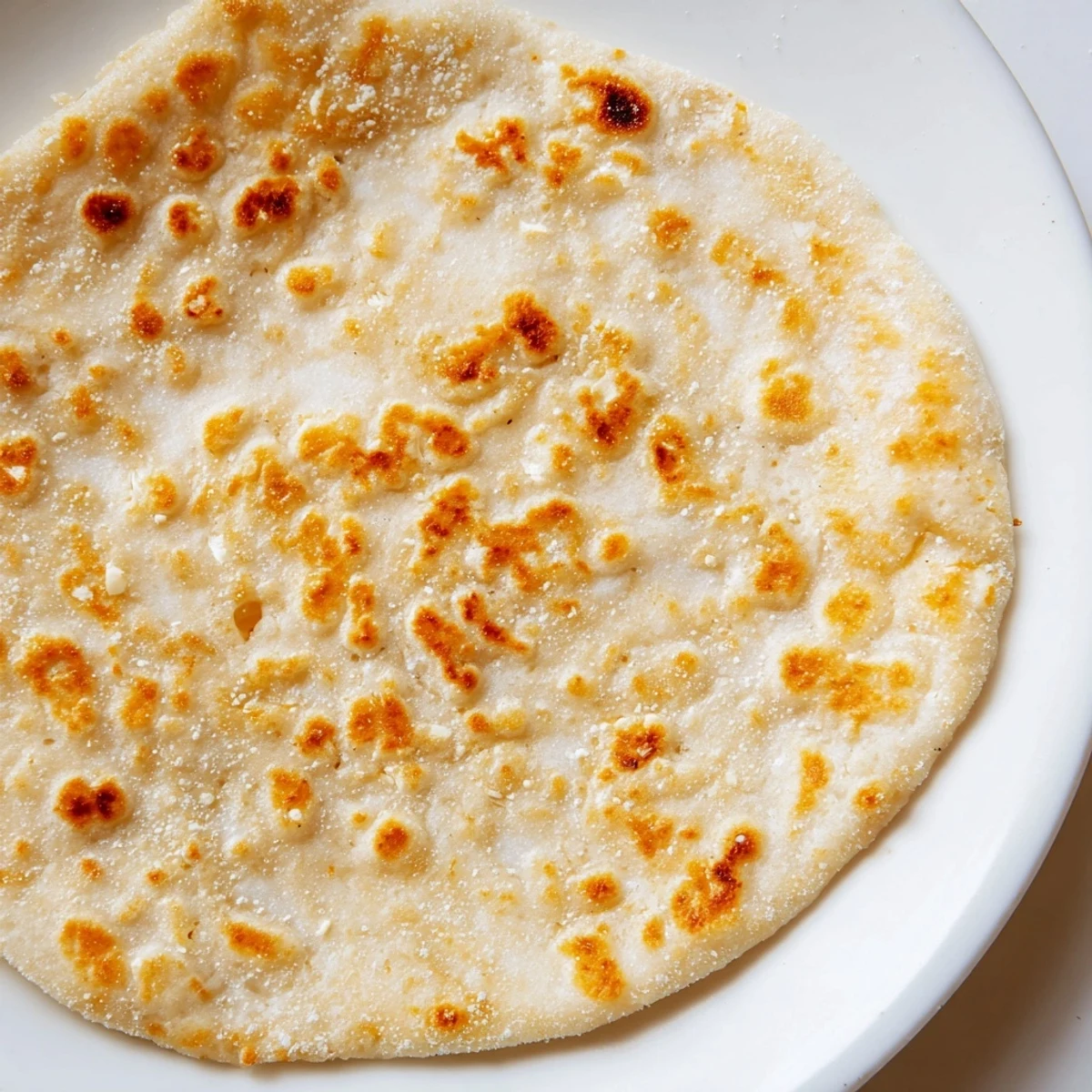 Golden cottage cheese flatbreads sizzling in a pan, ready to be enjoyed with a warm spread.