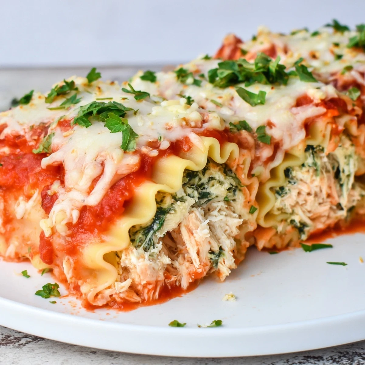Chicken and Spinach Lasagna Rolls bubbling with melted mozzarella, a comforting Italian-American main dish.