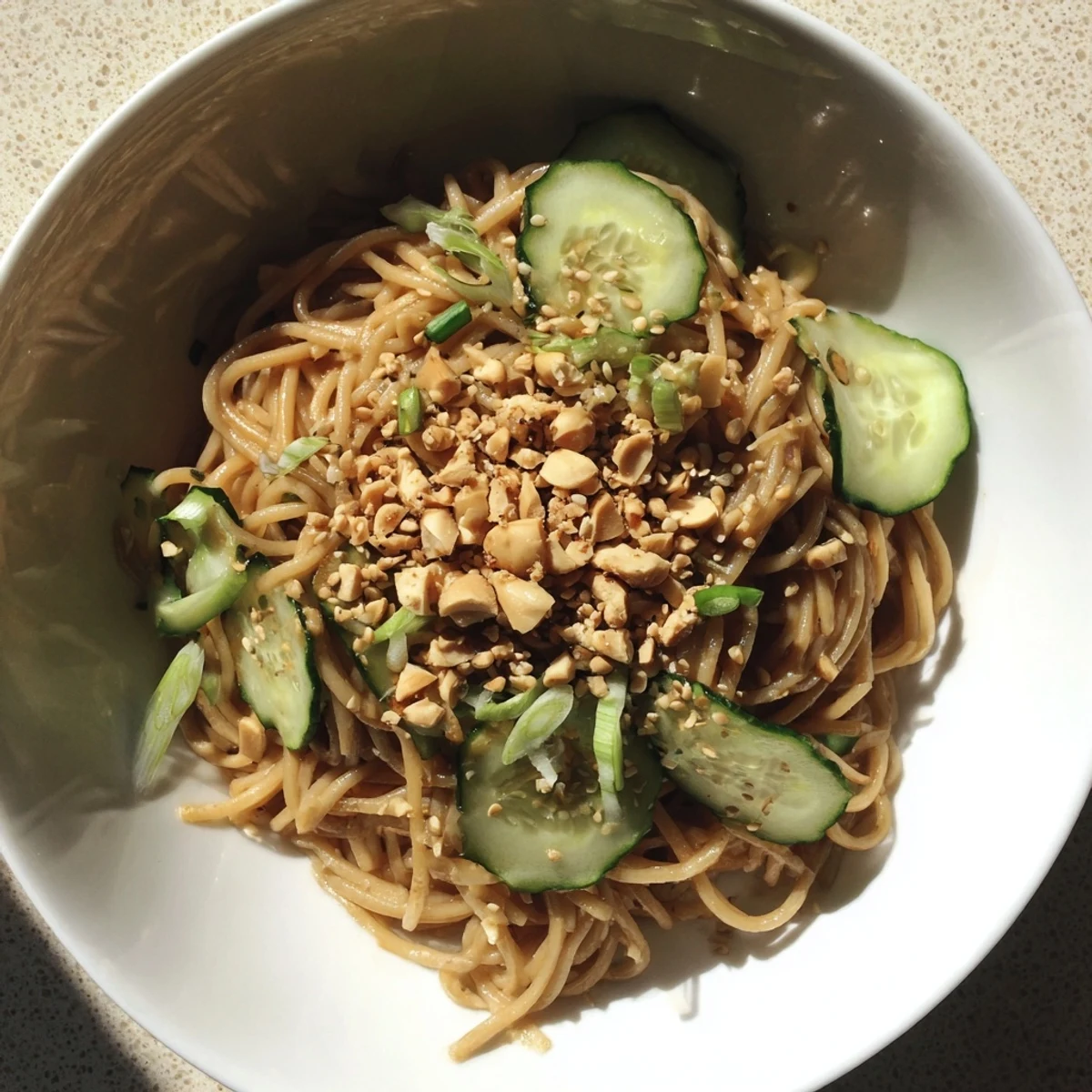 Spicy Sesame Noodle Salad: chilled noodles glistening in a flavorful sesame-chili dressing, ready to eat.