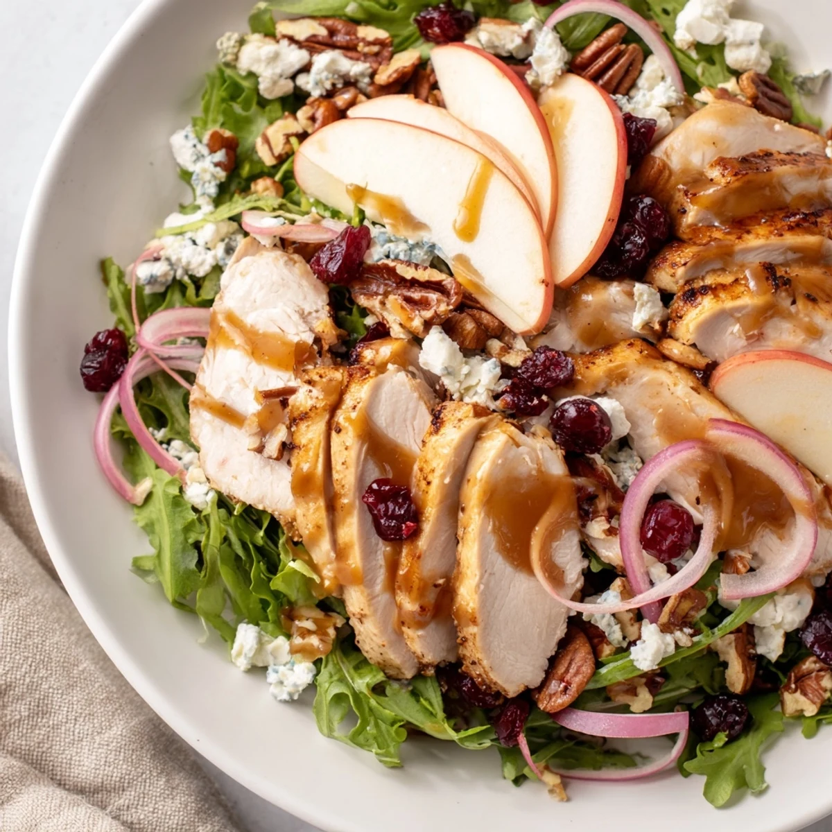 This Caramel Apple Chicken Salad features colorful ingredients and looks refreshing, ready to be enjoyed.