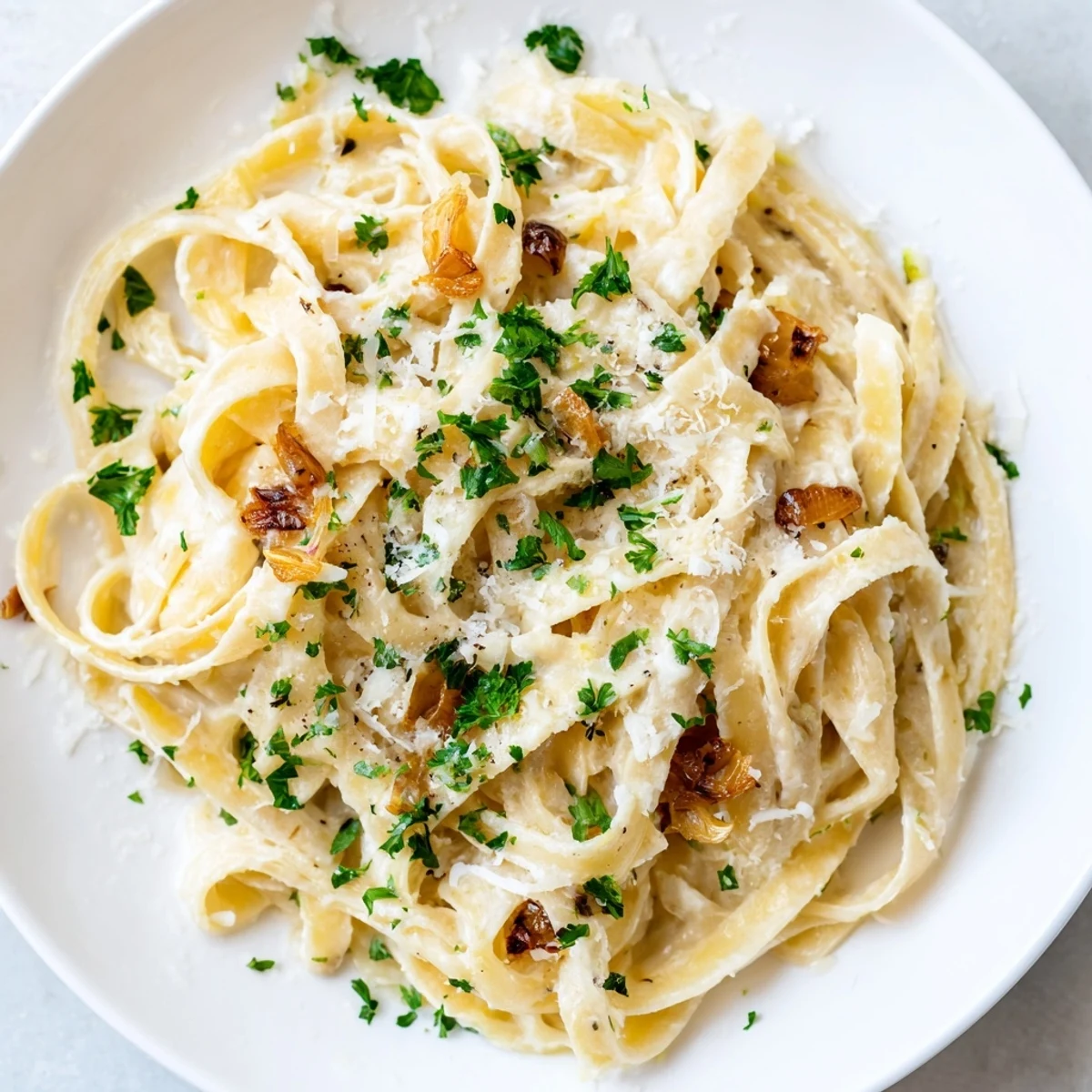 Creamy Roasted Garlic Cream Pasta topped with fresh Parmesan, ready to serve as a comforting Italian meal.