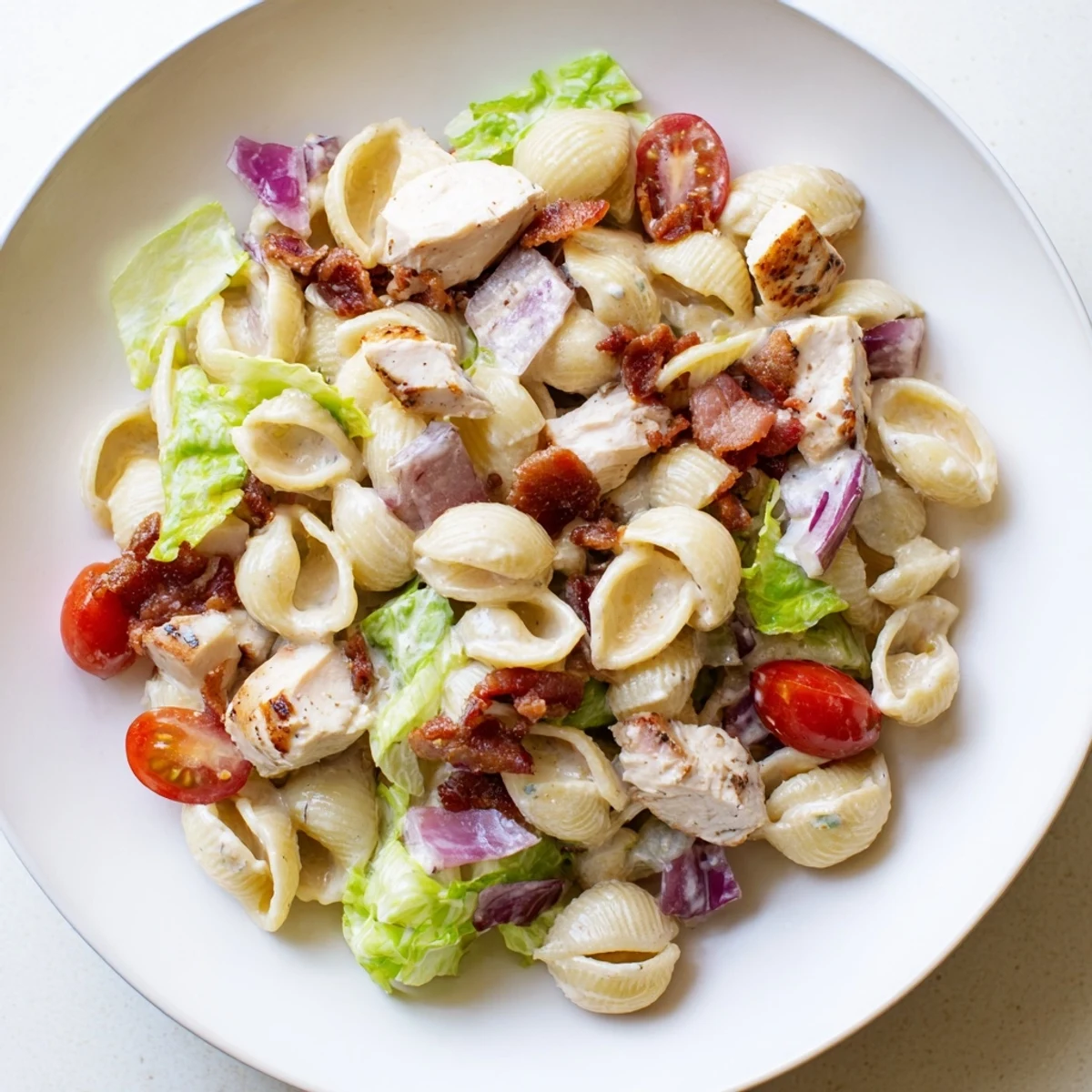 Creamy BLT Chicken Pasta Salad with grilled chicken and bacon, perfect for a picnic or quick lunch.