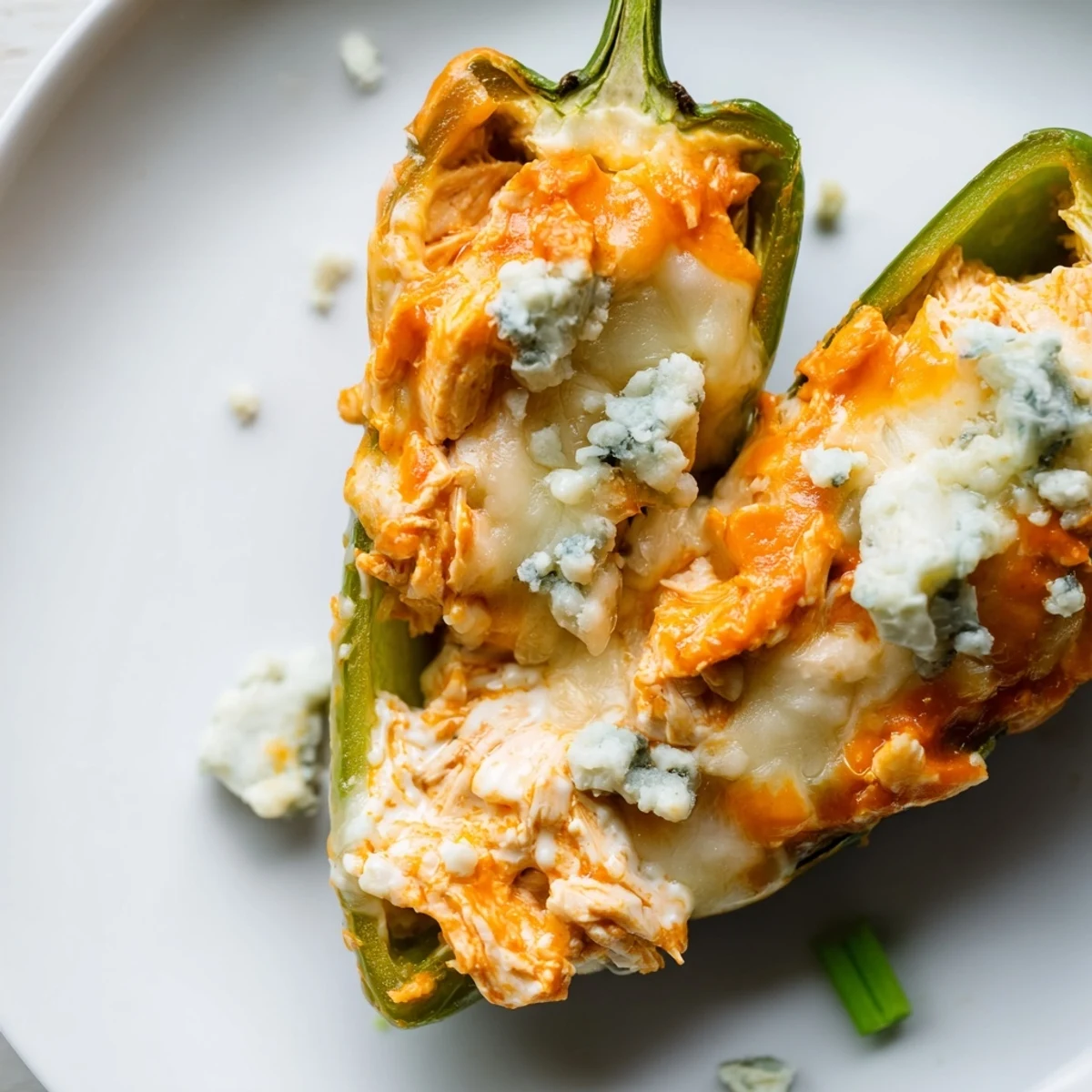 Ripe, green jalapeño halves overflowing with shredded chicken and creamy blue cheese Buffalo Wing Poppers, baked golden.