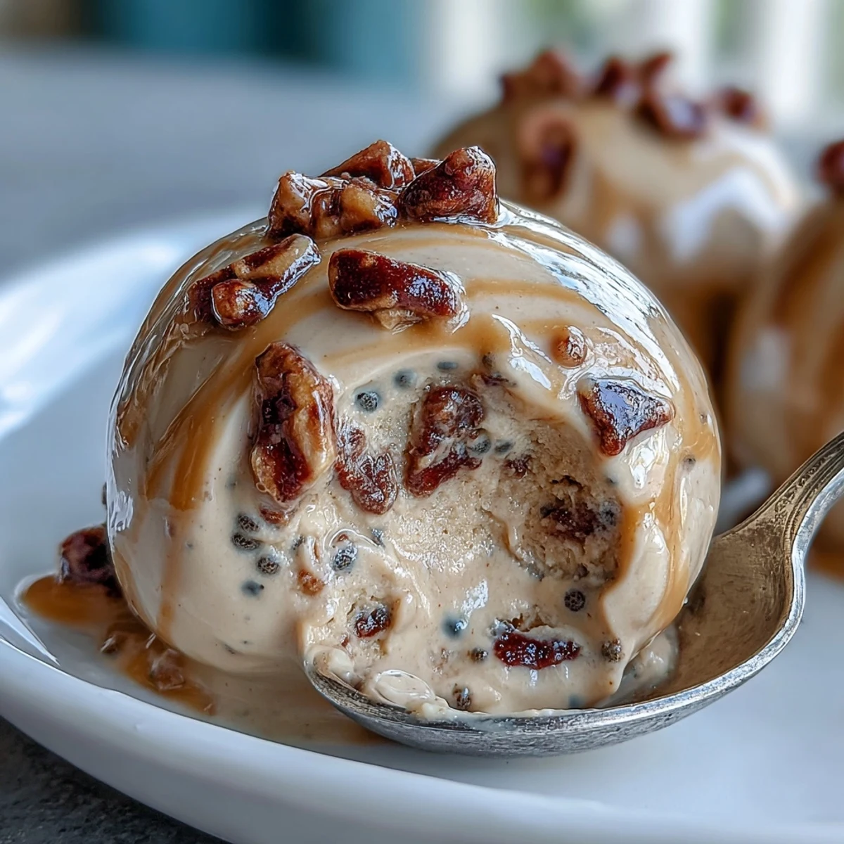 Perfectly frozen Frozen Greek Yogurt Peanut Butter Bites served in a small bowl, topped with crushed peanuts and berries.