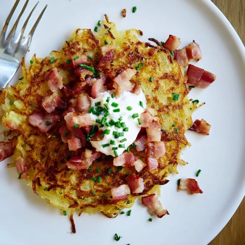 Crispy potato pancakes with bacon and sour cream, perfect for a hearty brunch.  
