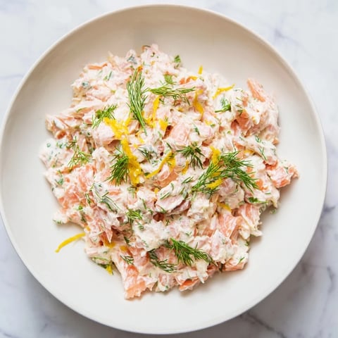 Creamy Dill & Horseradish Salmon Spread, a flavorful appetizer, ready to scoop onto crackers with a tangy bite.