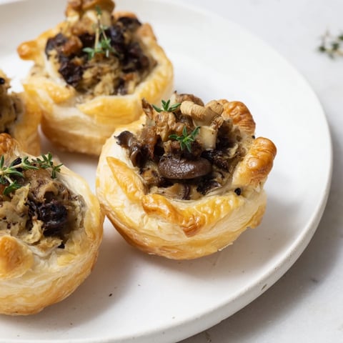 Creamy Mushroom & Chestnut Pâté Tartlets, golden brown and garnished with fresh thyme.