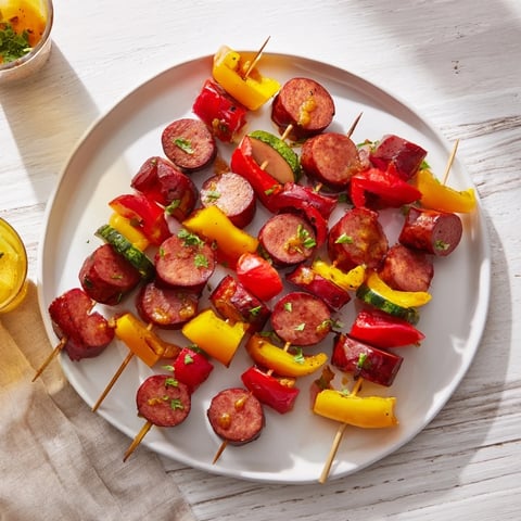 Lightened Kielbasa Appetizer Skewers glistening with a tangy glaze, ready to serve as a tasty party snack.