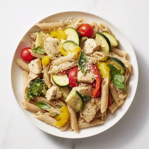 Vibrant 5-4-3-2-1 Pasta Primavera, featuring colorful veggies, chicken, and creamy Parmesan cheese.