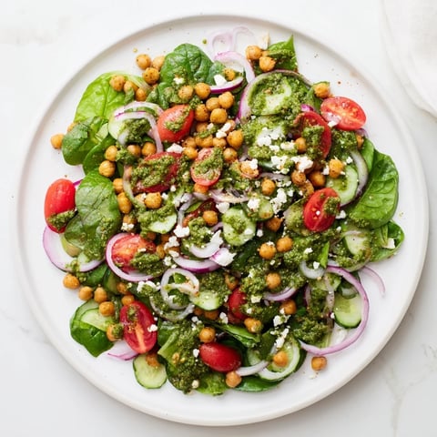 Creamy pesto chickpea and spinach salad, a vibrant vegetarian lunch, ready in just 15 minutes.