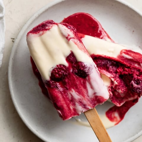 Creamy, refreshing raspberry coconut ice pops, a colorful frozen dessert ready for a summer day.