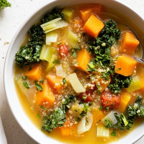 Hearty Nourishing Winter Veggie Soup, a steaming bowl filled with colorful vegetables and fresh parsley.