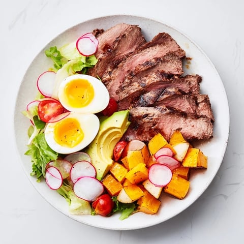 High-Protein Beef Avocado Bowl, featuring seared beef, ripe avocado and a golden-yolked egg.