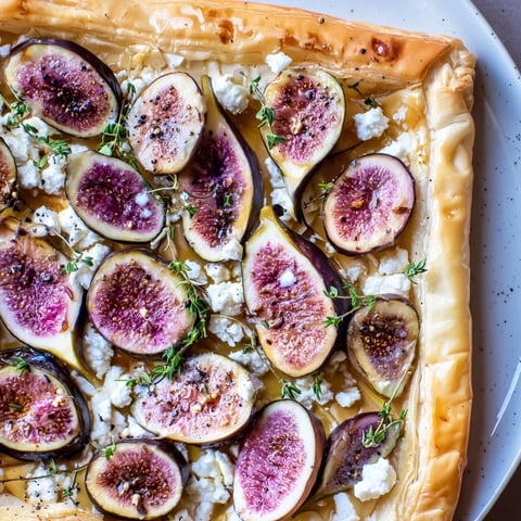 Puff Pastry Truffle Pizza with figs and goat cheese, glistening with truffle oil and ready to serve.