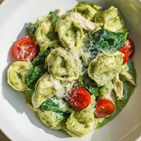 Creamy Pesto Tortellini Skillet, a bubbling pan of cheesy, herb-infused pasta and tender chicken.