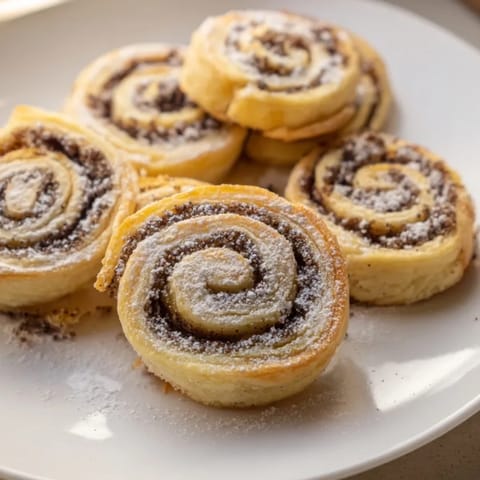 Golden brown Christmas Poppy Seed Roll Cookies, fresh from the oven; perfect with coffee or tea.