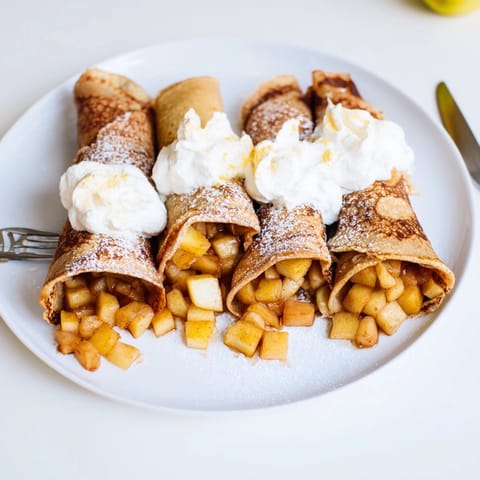 Golden brown Mini Apple Nalesniki recipe: Polish crepes, dusted with powdery sugar served warm.