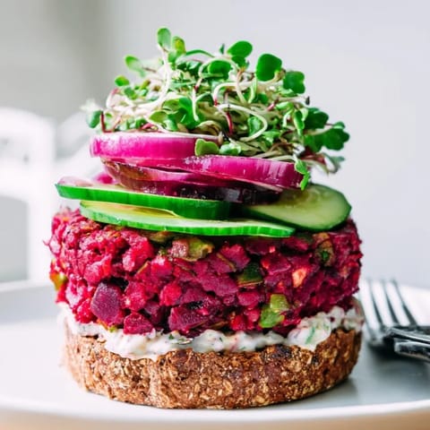 Elevated view: Juicy homemade Beet Burger recipe with creamy, tangy horseradish sauce visible.