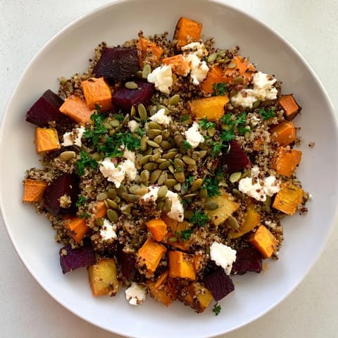 A brightly-lit shot of the Warm Quinoa and Roasted Root Vegetable Salad, ready to eat.