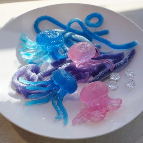 Vibrant Jellyfish Candy Platter with gummy jellyfish and shimmering, ocean-inspired sweets on display.