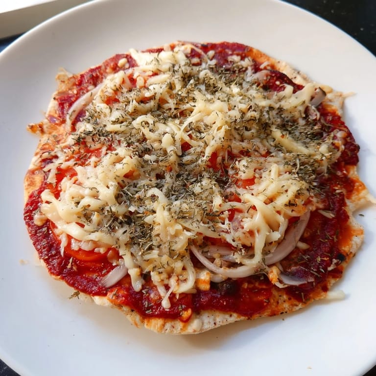 A close-up shot of homemade flatbread pizza, showcasing melted cheese and vibrant, affordable toppings.