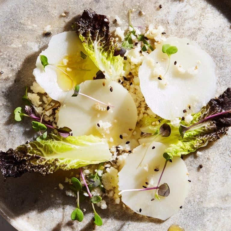 This The Tundra Trek features thinly sliced radish and endive, with a light lemon dressing.