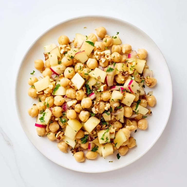 A colorful bowl of Fall Harvest Apple and Chickpea Salad, perfect for a light vegetarian lunch or side.
