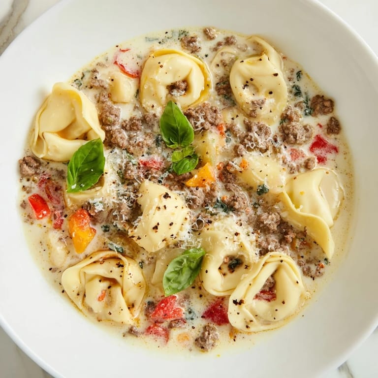 A close-up of a creamy Tortellini Beef Soup, showcasing the cheesy tortellini and beef.