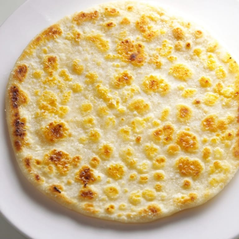 A stack of fluffy cottage cheese flatbread, perfect for dipping or enjoying as a wrap.