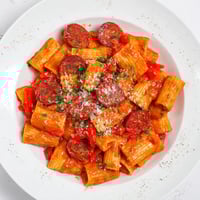 Savory Spanish chorizo pasta, coated in a rich tomato sauce, ready to serve with cheese.
